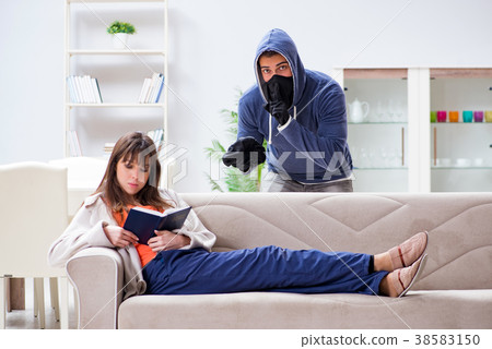 Armed man assaulting young woman at home 38583150