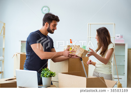 Young family unpacking at new house with boxes 38583189