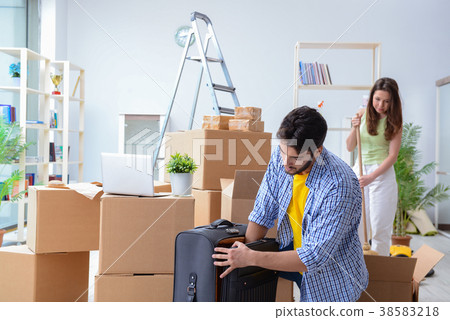 Young family unpacking at new house with boxes 38583218