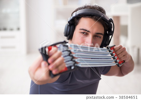 Man doing sports with resistance band and 38584651