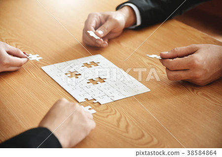 Business people hands are holding jigsaw puzzle. Business people hands are holding jigsaw puzzle. 38584864