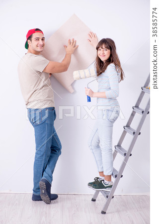 Young family doing renovation at home with new Young family doing renovation at home with new 38585774