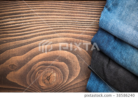 Jeans on wooden board with copy space Jeans on wooden board with copy space 38586240