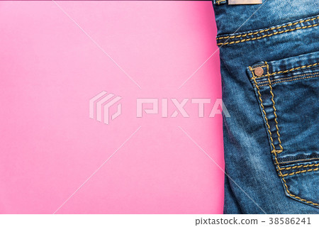 Blue jeans on pink pastel background Blue jeans on pink pastel background 38586241