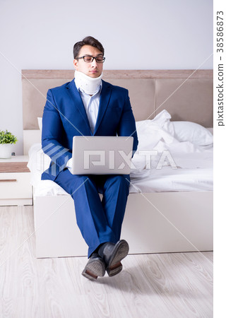Businessman with neck injury working from home 38586873