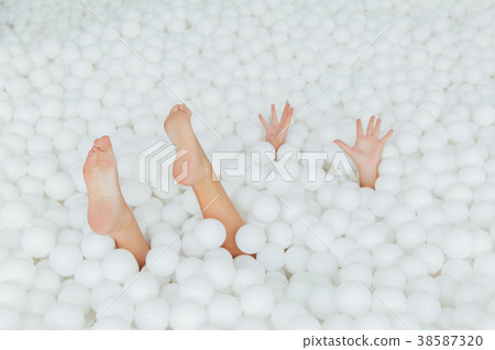 woman body parts stick out white plastic balls in woman body parts stick out white plastic balls in 38587320