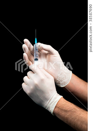 Male hands in latex gloves holding a syringe 38587690