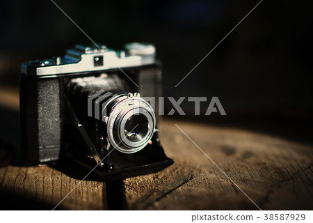 Vintage old camera on a wooden table. 38587929