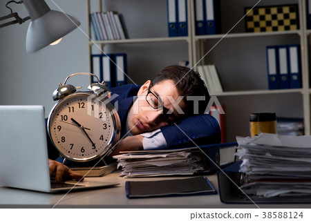 Businessman falling asleep during long hours in 38588124
