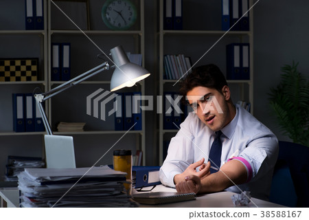 Employee relieving stress from overtime with drugs 38588167
