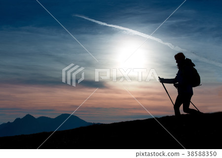 Silhouette of a girl on a mountain during a religious trek in a 38588350
