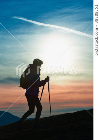 Silhouette of a girl on a mountain during a religious trek Silhouette of a girl on a mountain during a religious trek 38588351