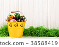 Easter eggs in bucket on white wooden background 38588419
