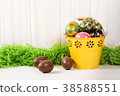 Easter eggs in bucket on white wooden background 38588551