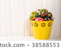 Easter eggs in bucket on white wooden background 38588553