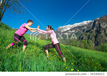 Two young girls playing in a meadow in a beautiful day. 38588823