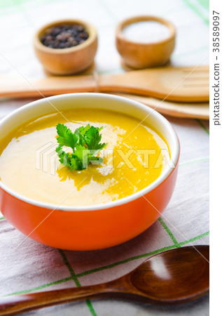Pumpkin soup served on the table in bowl 38589097