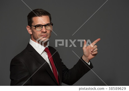 Cute businessman posing in studio Cute businessman posing in studio 38589629