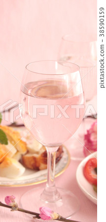 Wineglass and snacks 38590159