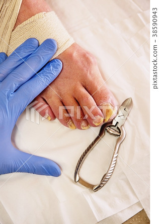 Pedicurist in gloves cut nails. Hardware manicure Pedicurist in gloves cut nails. Hardware manicure 38590943