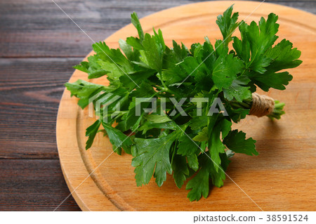 Fresh green parsley on the wooden table Fresh green parsley on the wooden table 38591524