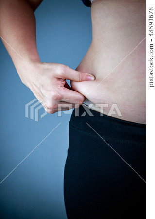 Woman checking fat on abdomen. Overweight concept 38591678