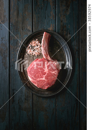Raw tomahawk steak 38592974
