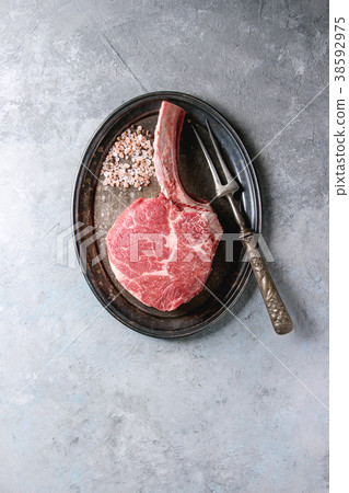 Raw tomahawk steak 38592975