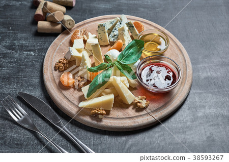 Cheese plate with cheeseson the table from  38593267