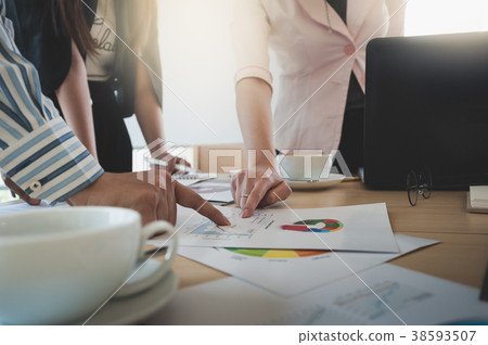 Businesspeople poiting at document on table Businesspeople poiting at document on table 38593507