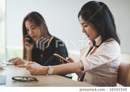 Young woman worker talking with smartphone Young woman worker talking with smartphone 38593509