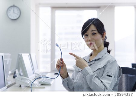 Woman in work clothes with LAN cable 38594357