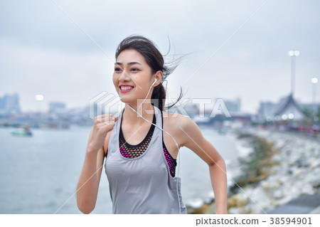 Sports concept. Beautiful girl is exercising on the beach with r 38594901