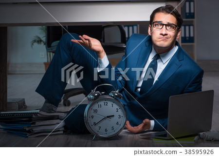 Businessman working overtime long hours late in Businessman working overtime long hours late in 38595926