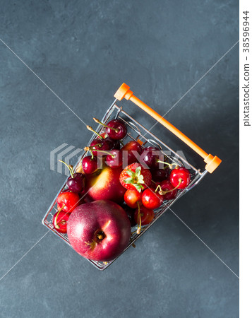 Fresh red fruit berries supermarket cart on black 38596944