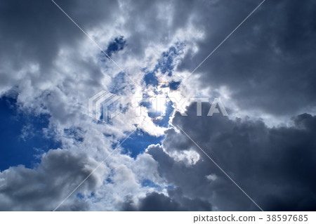 Blue sky and sun covered by rain clouds 38597685