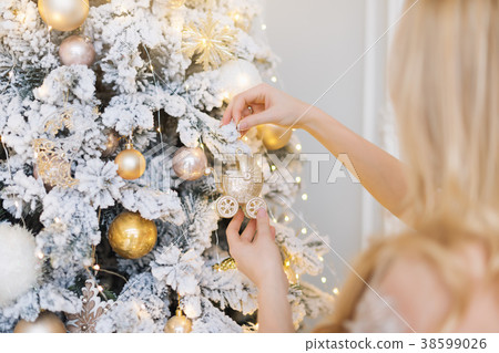 Woman decorating the New Year tree. Christmas tree Woman decorating the New Year tree. Christmas tree 38599026