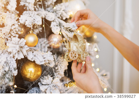 Woman decorating the New Year tree. Christmas tree Woman decorating the New Year tree. Christmas tree 38599027