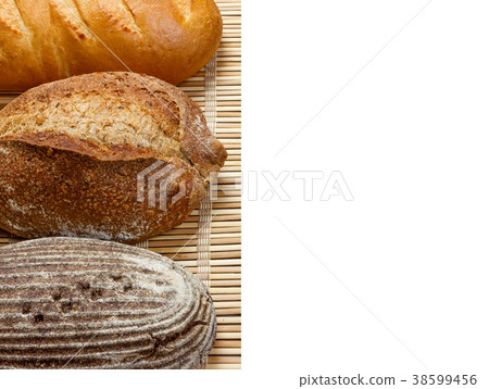 Different fresh bread on wooden plank, isolated Different fresh bread on wooden plank, isolated 38599456