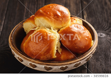 Homemade sweet bread rolls on dark background. Homemade sweet bread rolls on dark background. 38599816