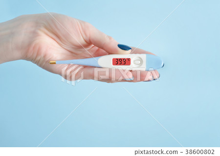 Electronic thermometer in a female hand Electronic thermometer in a female hand 38600802