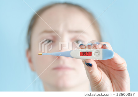 Woman with a thermometer in his hand. Increased 38600887
