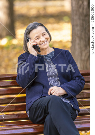 Senior woman talking on smartphone outdoors Senior woman talking on smartphone outdoors 38602000