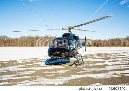 solo black helicopter in blue skies with snow solo black helicopter in blue skies with snow 38602192