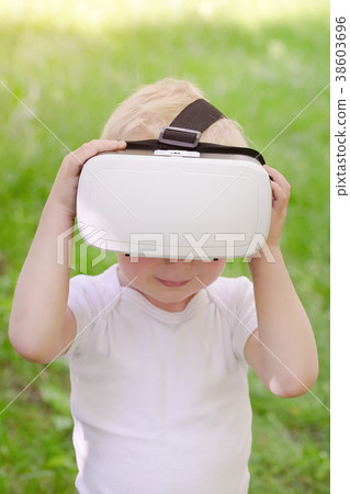 Little boy in a virtual reality helmet Little boy in a virtual reality helmet 38603696
