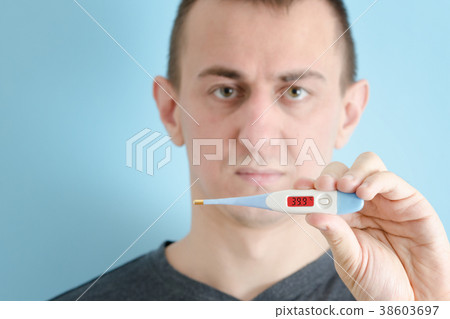 Man with a thermometer in his hand 38603697