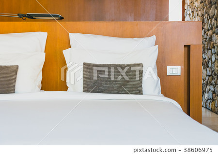 Confortable white pillow on bed Confortable white pillow on bed 38606975