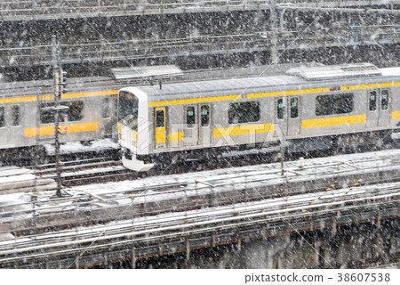 Commuter train during snowfall 38607538