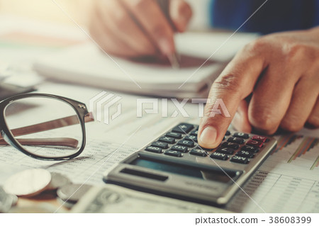 accountant using calculator to calculate budget accountant using calculator to calculate budget 38608399