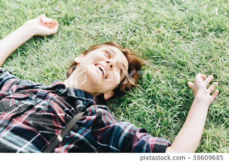 Woman lying on the grass (relaxed image) Woman lying on the grass (relaxed image) 38609685